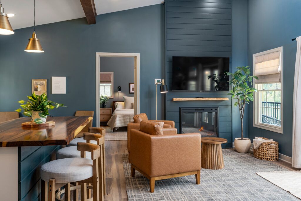 Deep blue living room with leather chairs and built-in cabinetry