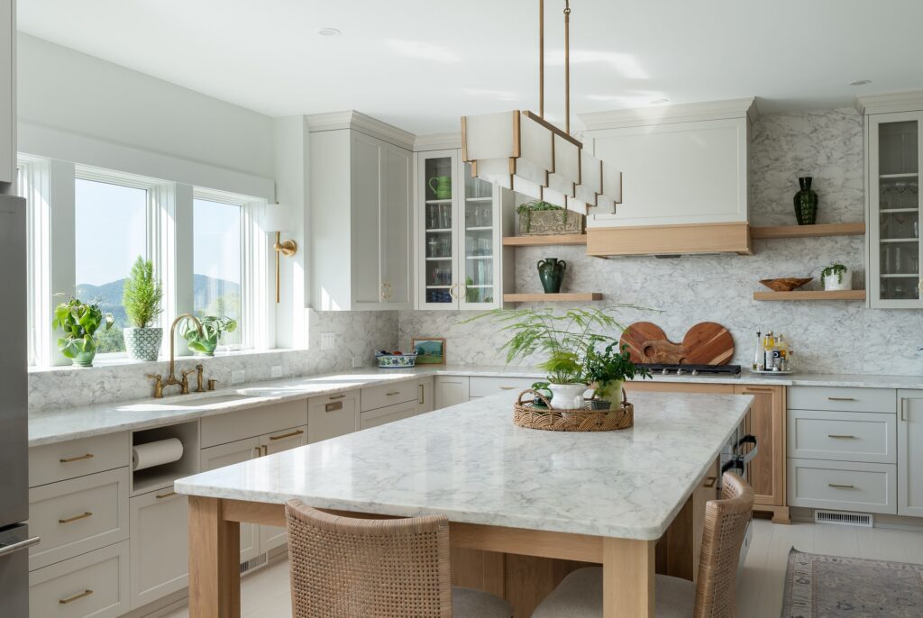 Light-filled kitchen with marble island and custom cabinetry